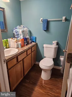 a bathroom with a sink mirror vanity and toilet