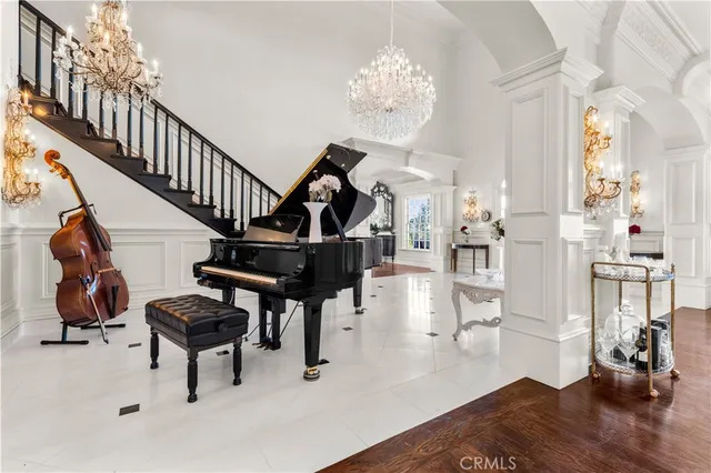 a living room with furniture a fireplace and a chandelier