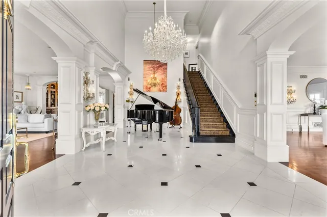 a living room with furniture and a chandelier