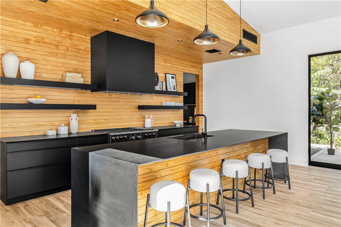 11851 Hopes Creek Road College Station, TX 77845 - Photo 16 of 50 a kitchen with stainless steel appliances granite countertop a sink and wooden cabinets