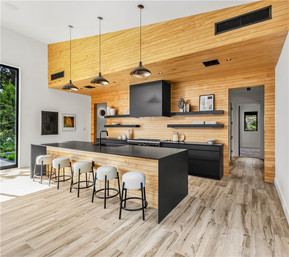 11851 Hopes Creek Road College Station, TX 77845 - Photo 17 of 50 a large kitchen with stainless steel appliances granite countertop a stove and cabinets with wooden floor