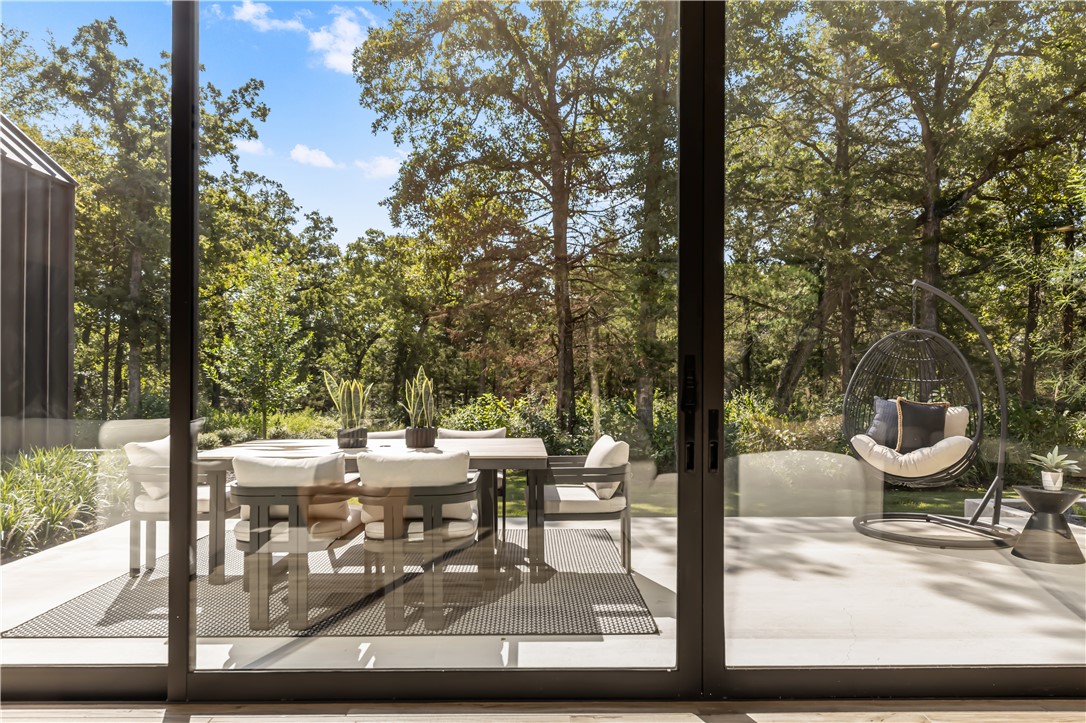 11851 Hopes Creek Road College Station, TX 77845 - Photo 21 of 50 a view of a patio with lawn chairs under an umbrella