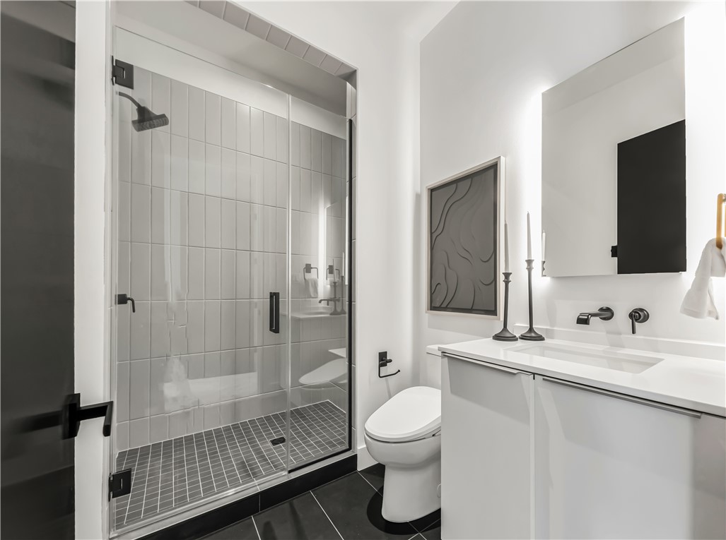 11851 Hopes Creek Road College Station, TX 77845 - Photo 39 of 50 a bathroom with a sink toilet a mirror and shower