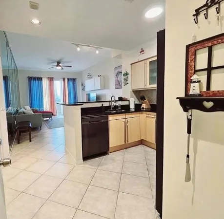 a kitchen with stainless steel appliances granite countertop white cabinets and black stove top oven with granite countertops