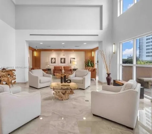 a living room with furniture a flat screen tv and a large window