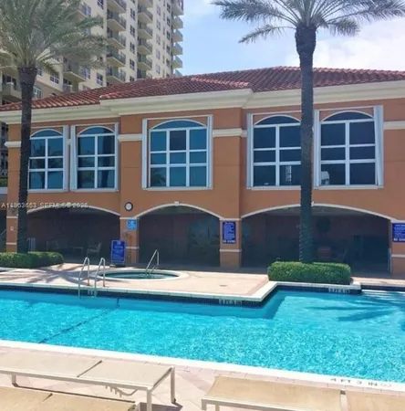 a view of a kitchen with kitchen island and a potted plant