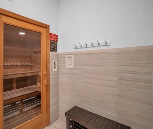 a large living room with stainless steel appliances kitchen island granite countertop furniture and a fireplace