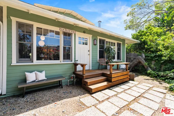 a view of a bench in front of a house