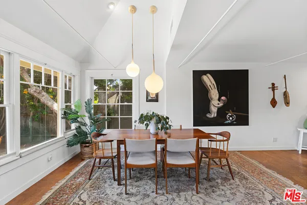 a dining room with furniture and window