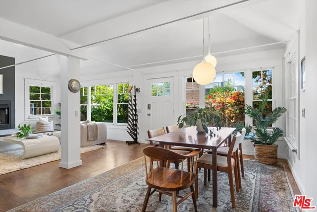 a dining room with furniture a chandelier and wooden floor