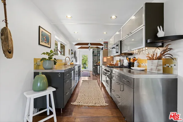 a kitchen with stainless steel appliances granite countertop a sink and a stove