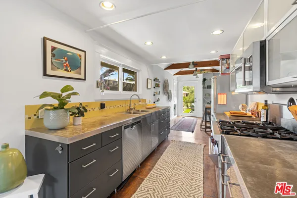 a large kitchen with a lot of counter space and a sink