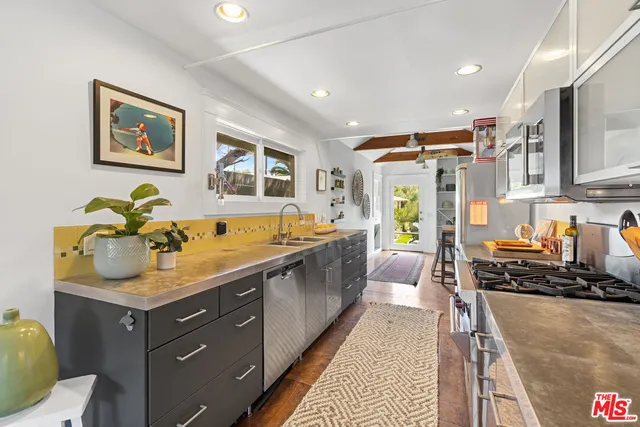 a large kitchen with a lot of counter space and a sink