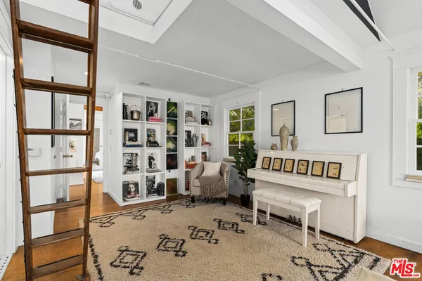 a bedroom with furniture and a book shelf