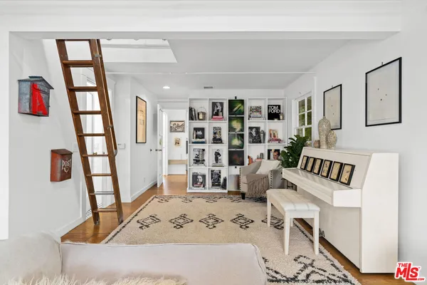 a view of a livingroom with furniture and staircase