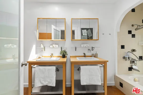 a bathroom with a bathtub sink and mirror