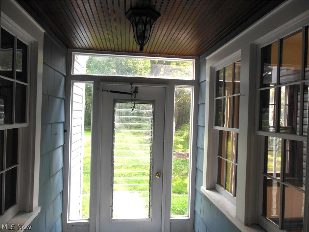 2129 Hubbard Road Madison, OH 44057 - Photo 23 of 27 Look at that beautiful wood wainscoting on the ceiling of this adorable little porch/breezeway area to the back door. Great place for muddy boots, and wet umbrellas!