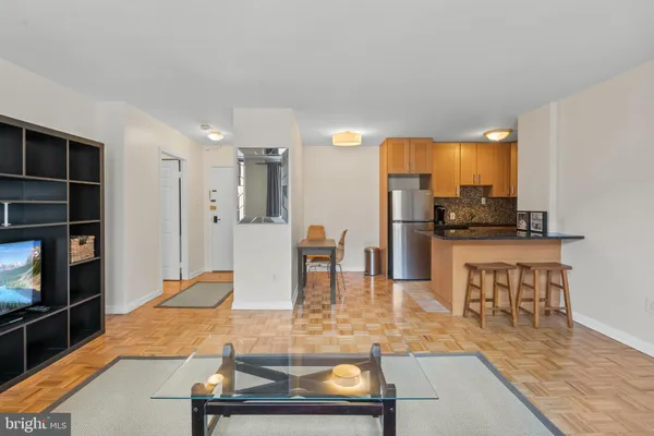 a room with table chairs and wooden floor