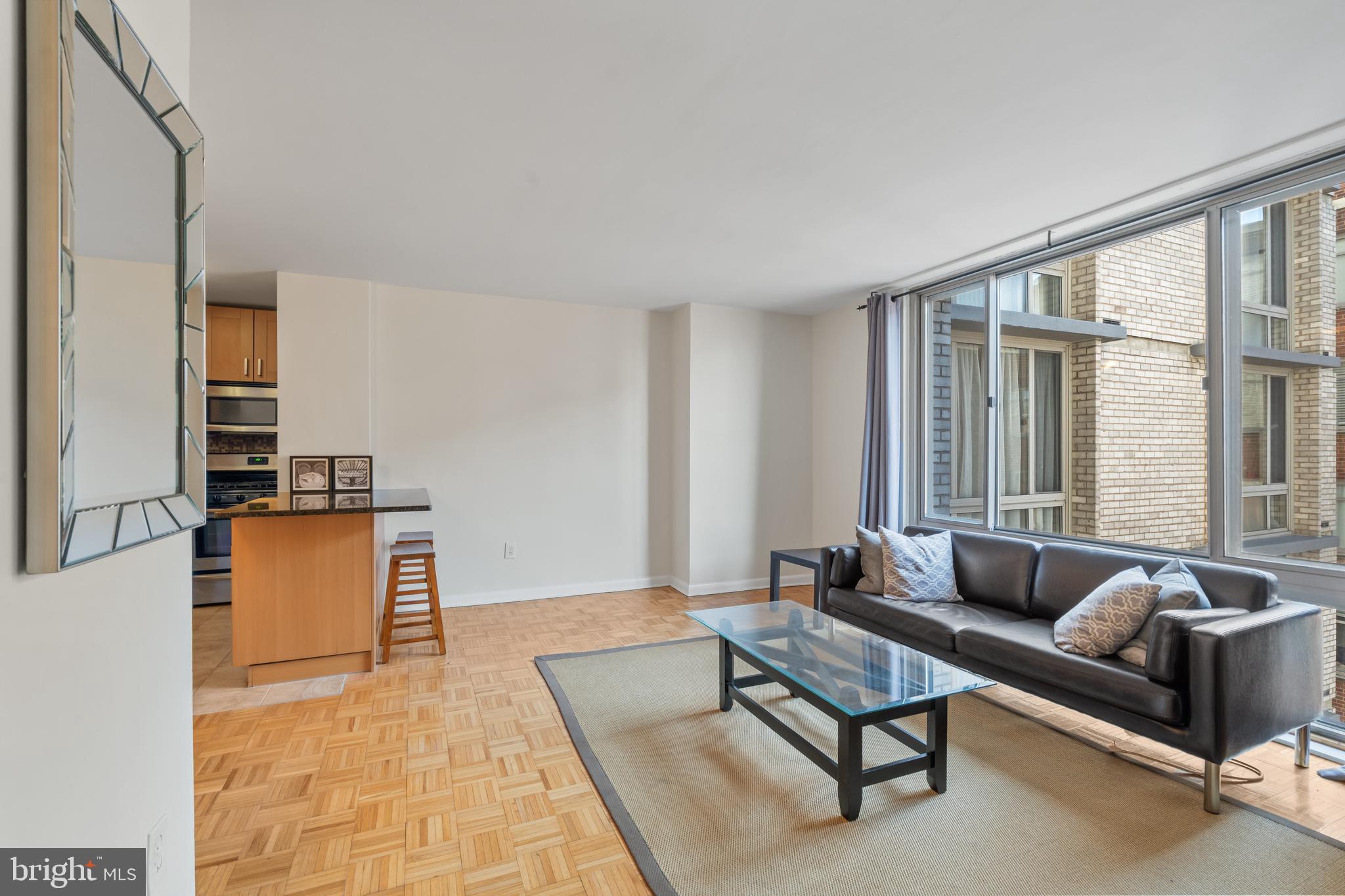 950 25th Street Northwest, Unit 717 Washington, DC 20037 - Photo 2 of 19 a living room with furniture and a large window