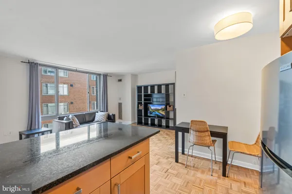 a kitchen with granite countertop a table and chairs in it