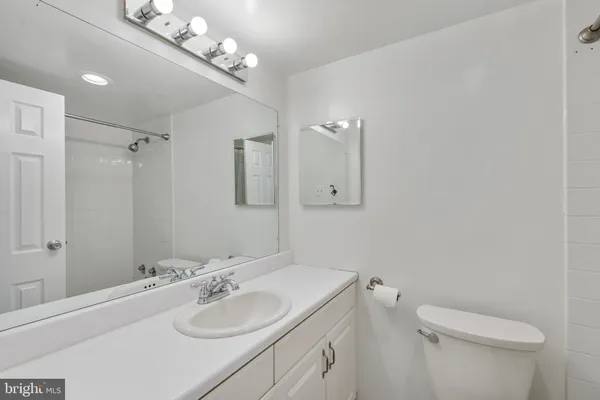 a bathroom with a sink a toilet and a mirror