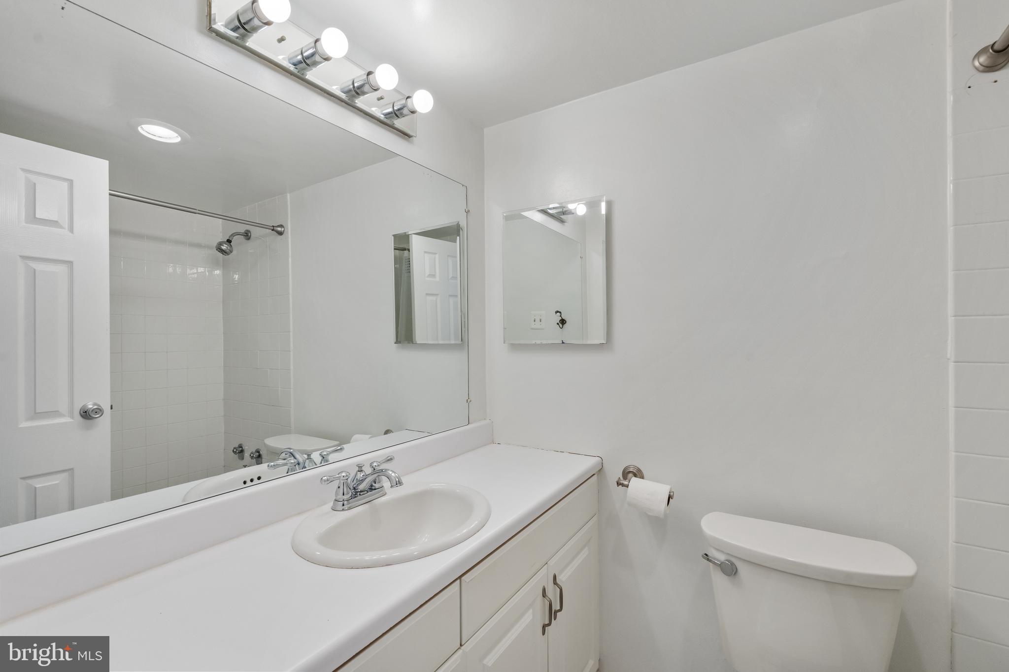 950 25th Street Northwest, Unit 717 Washington, DC 20037 - Photo 6 of 19 a bathroom with a sink a toilet and a mirror