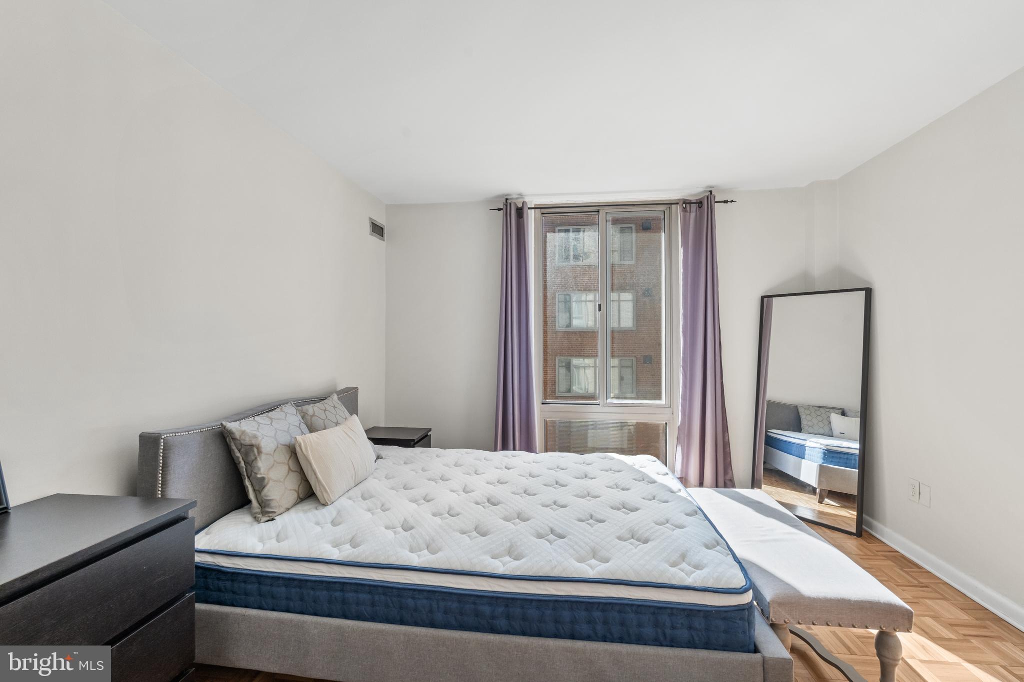 950 25th Street Northwest, Unit 717 Washington, DC 20037 - Photo 7 of 19 a bedroom with a bed and a window