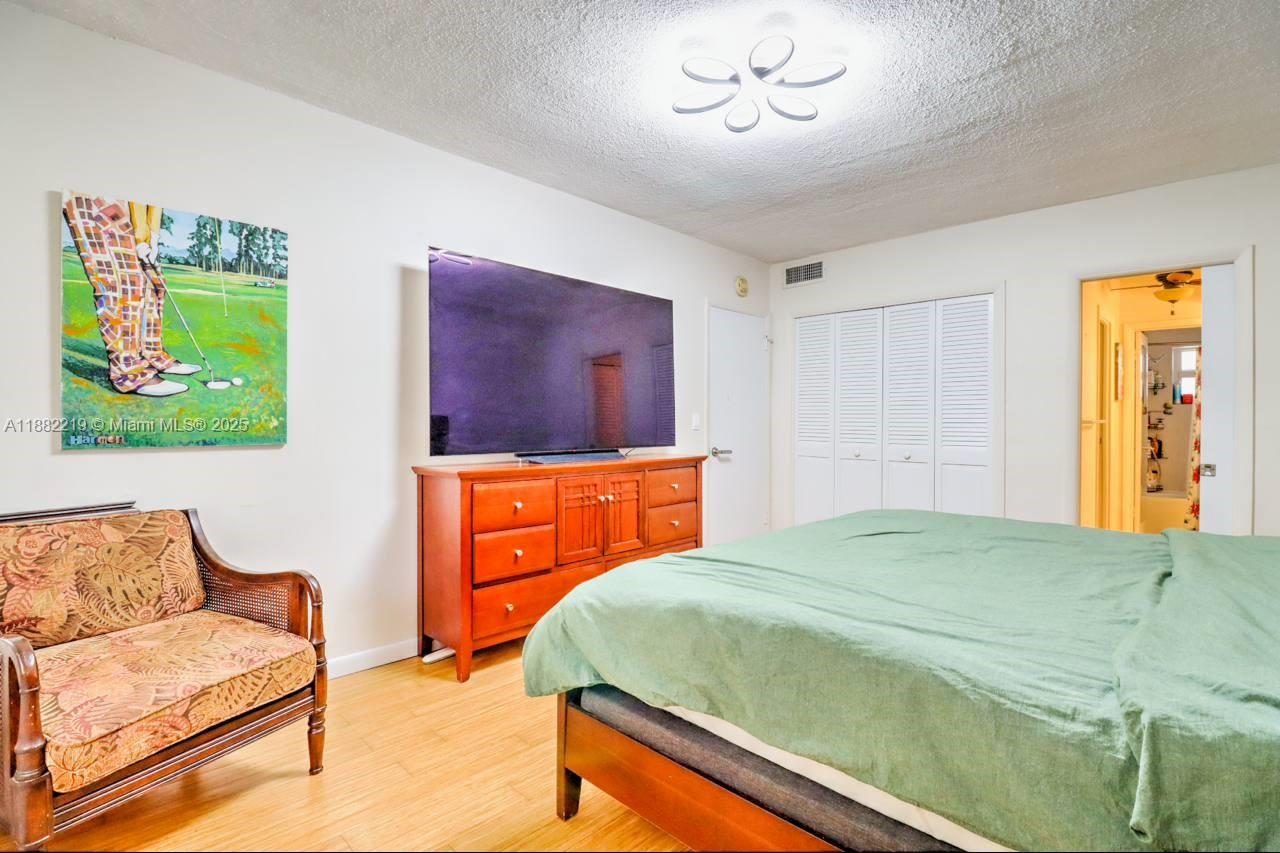 850 Northeast 12th Avenue, Unit 210 Hallandale Beach, FL 33009 - Photo 13 of 16 a bedroom with a bed and a couch