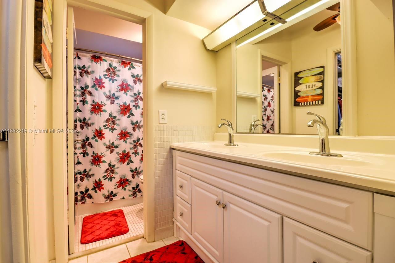 850 Northeast 12th Avenue, Unit 210 Hallandale Beach, FL 33009 - Photo 15 of 16 a bathroom with a sink and a mirror