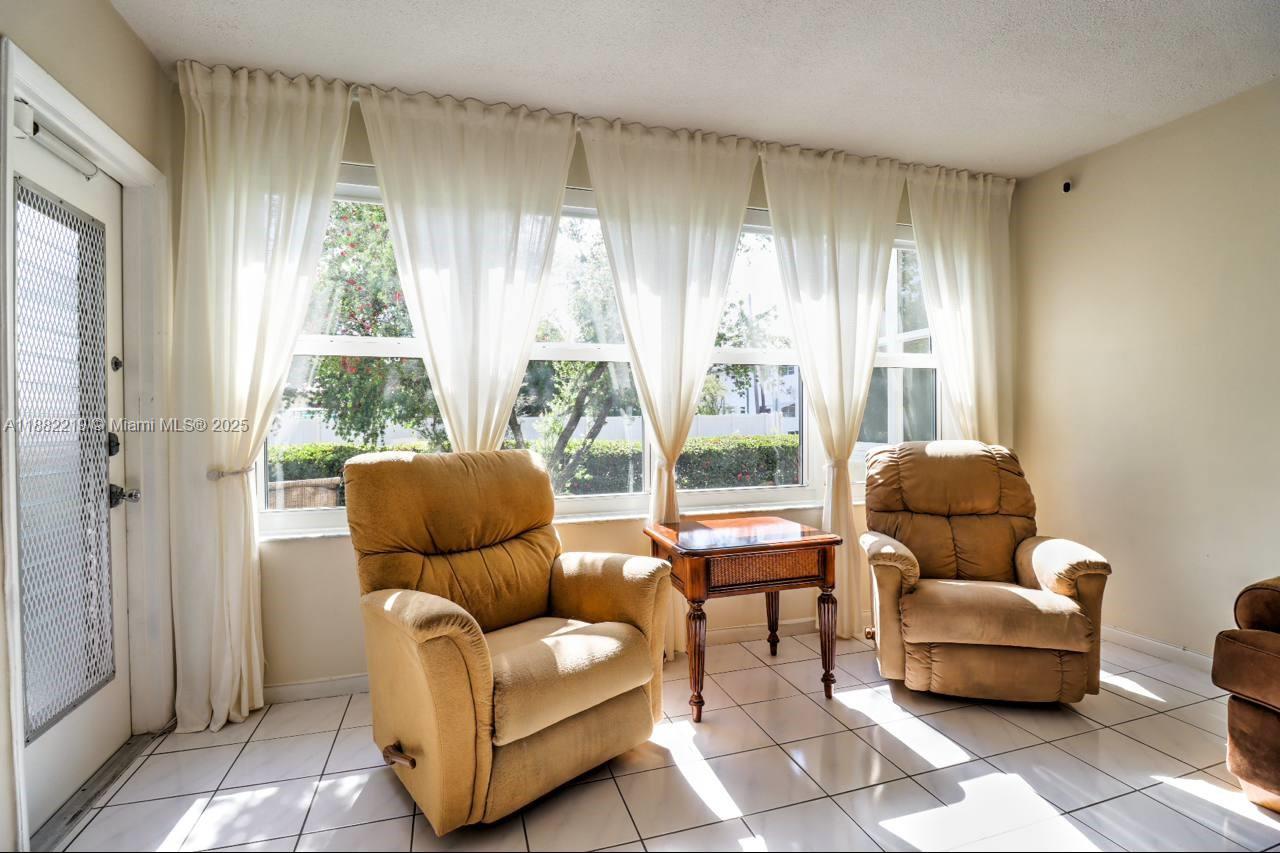 850 Northeast 12th Avenue, Unit 210 Hallandale Beach, FL 33009 - Photo 2 of 16 a living room with furniture and a window