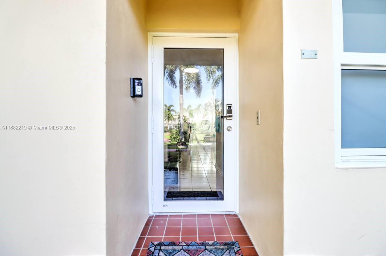 850 Northeast 12th Avenue, Unit 210 Hallandale Beach, FL 33009 - Photo 10 of 16 a view of a hallway with wooden floor