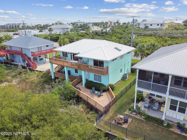 an aerial view of a house with a big yard