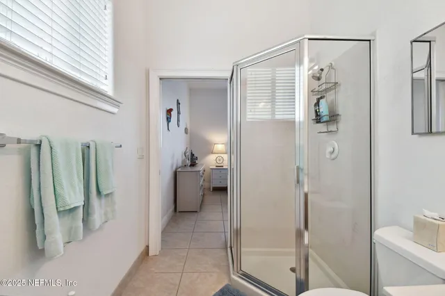 a living room with furniture a flat screen tv and white walls