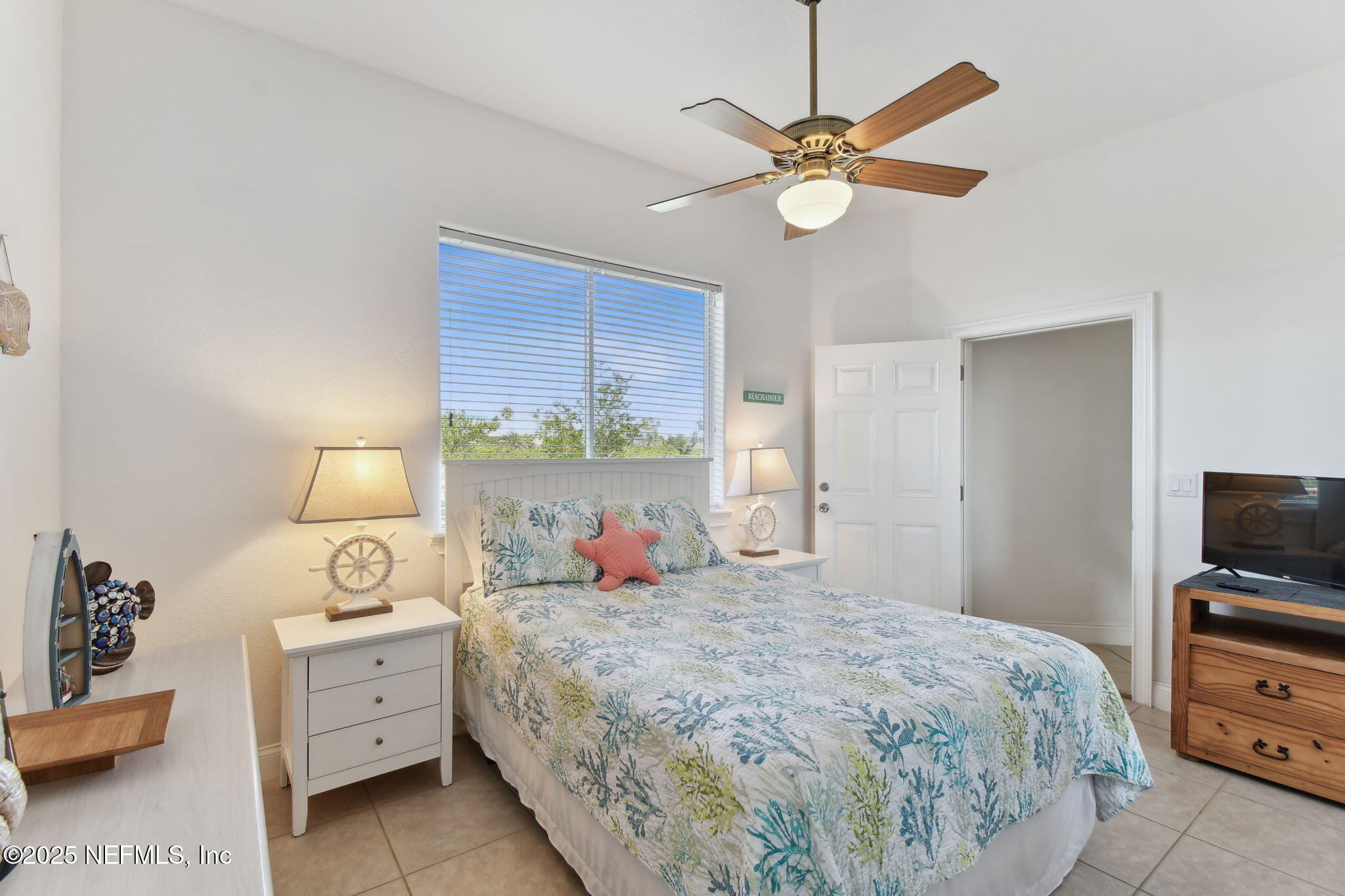 8961 A1A South St. Augustine, FL 32080 - Photo 20 of 62 a bedroom with a bed and a chandelier