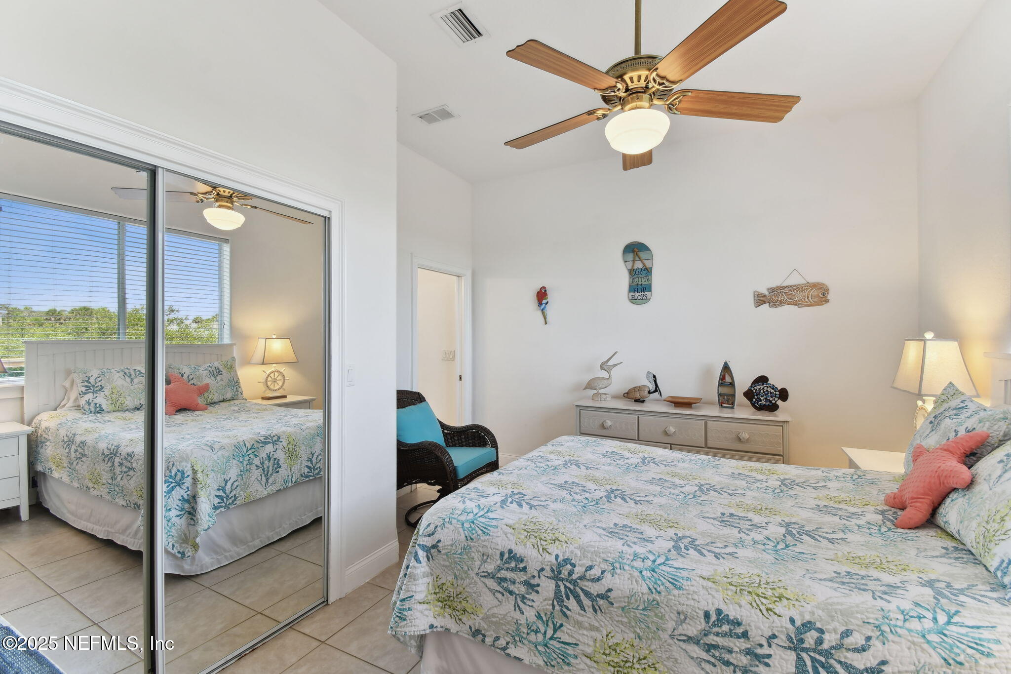 8961 A1A South St. Augustine, FL 32080 - Photo 21 of 62 a bedroom with a bed and a chandelier fan