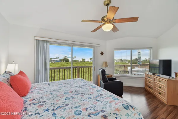 a view of a balcony with wooden floor & fence