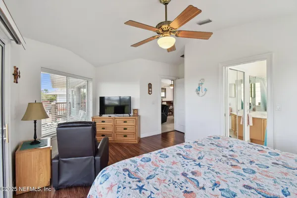 a view of a patio with table and chairs with wooden floor and fence