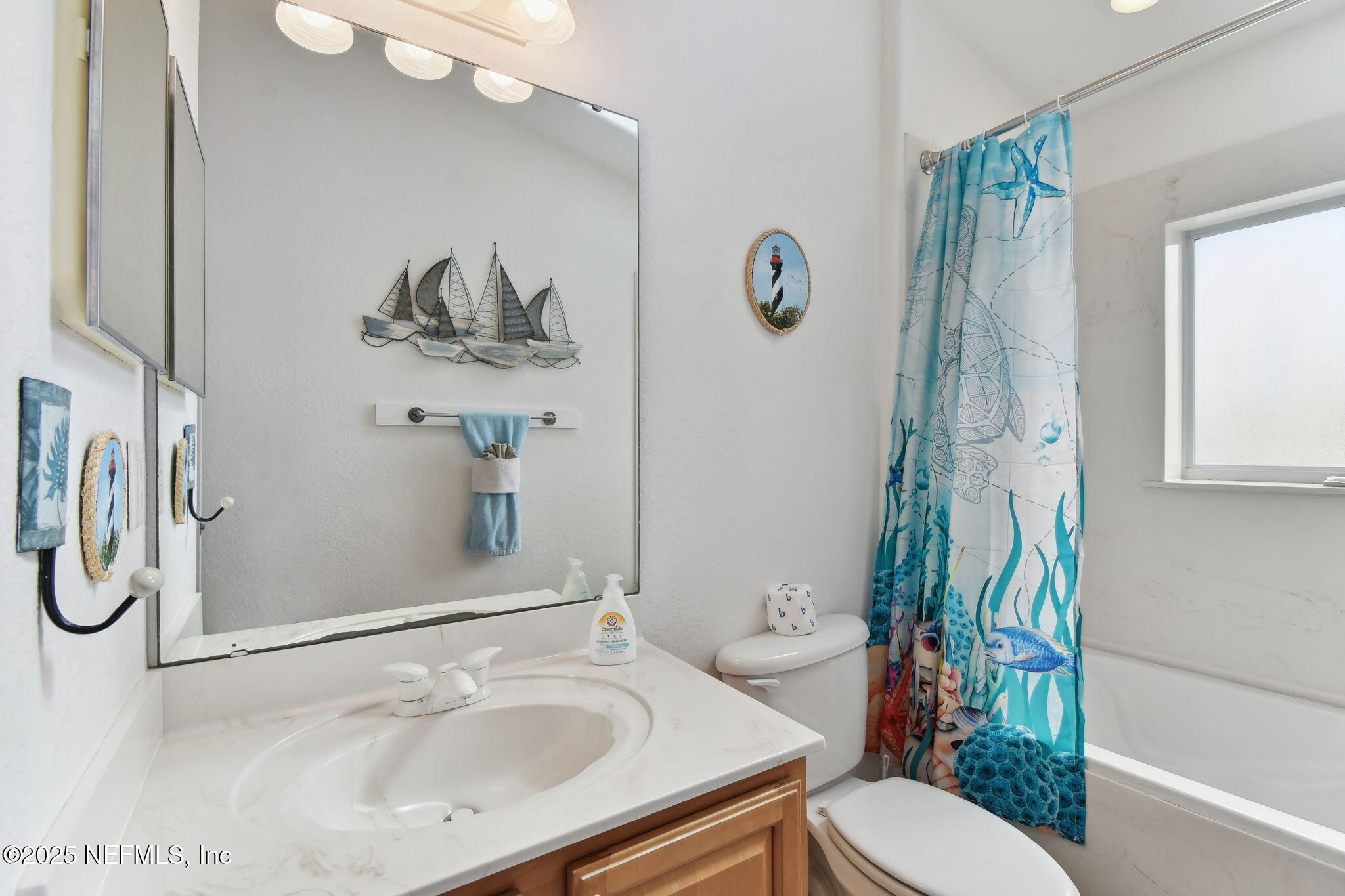 8961 A1A South St. Augustine, FL 32080 - Photo 45 of 62 a bathroom with a sink a toilet and a mirror