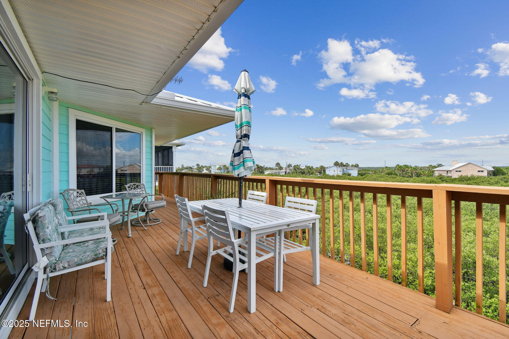 8961 A1A South St. Augustine, FL 32080 - Photo 47 of 62 a view of a patio with table and chairs with wooden floor and fence