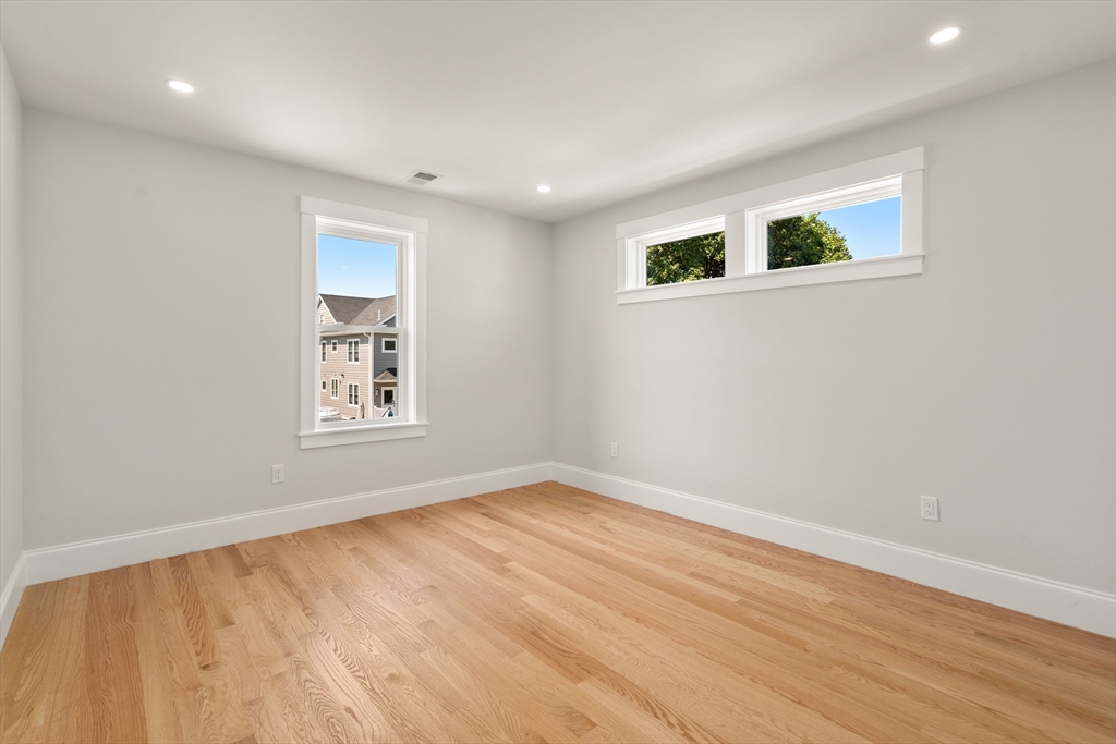 48 Hamilton Road Belmont, MA 02478 - Photo 23 of 35 a view of an empty room with wooden floor and a window