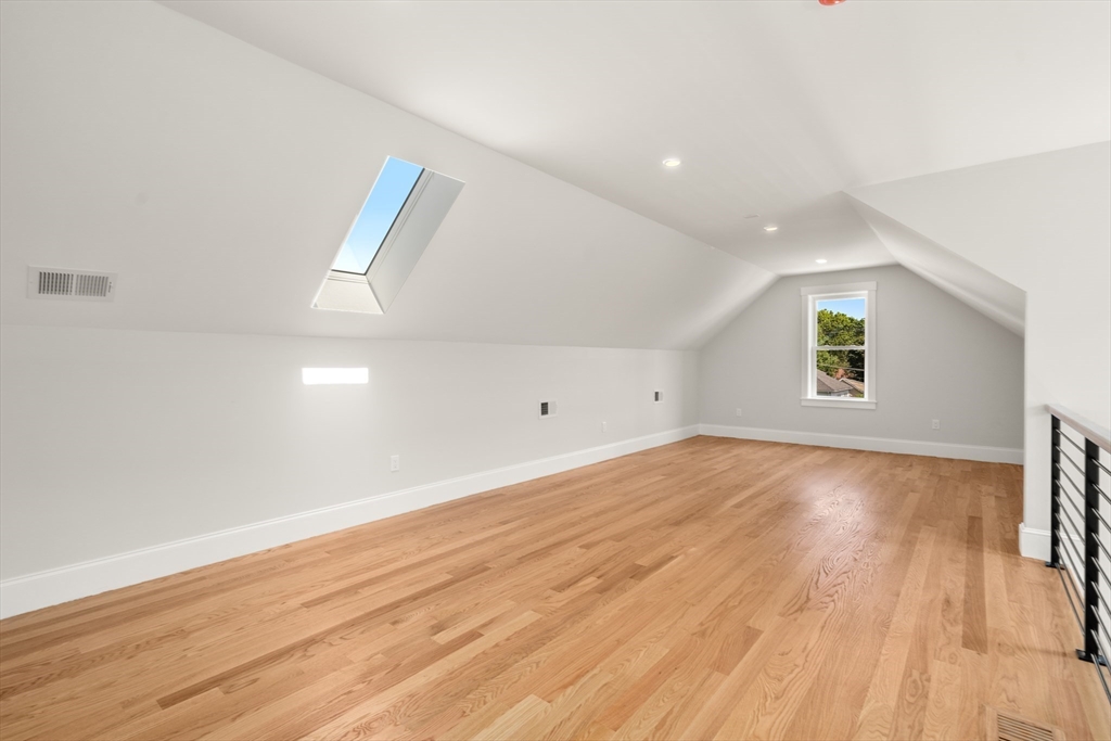 48 Hamilton Road Belmont, MA 02478 - Photo 28 of 35 an empty room with wooden floor and windows