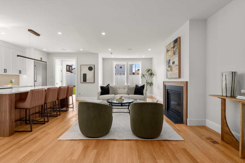 48 Hamilton Road Belmont, MA 02478 - Photo 10 of 35 a living room with furniture a fireplace and a table