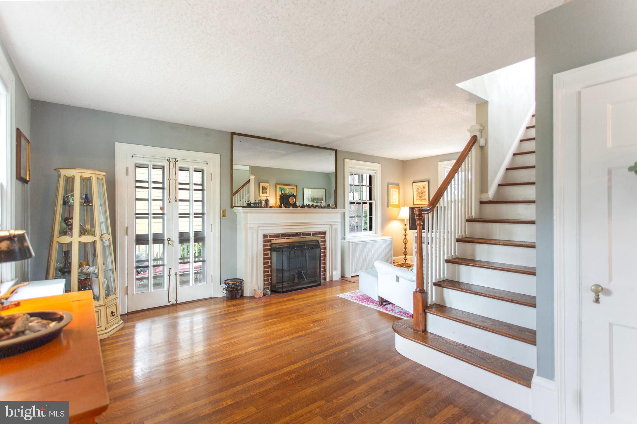719 Brookwood Road Baltimore, MD 21229 - Photo 6 of 40 Large living room with access to screened porch