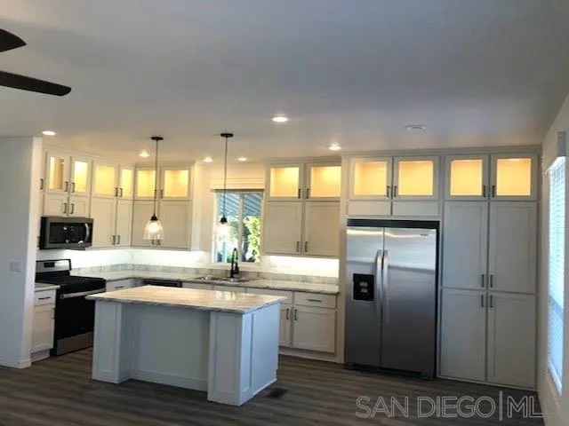 1315 Pepper Drive, Unit 18 El Cajon, CA 92021 - Photo 2 of 10 a kitchen with stainless steel appliances granite countertop a sink a stove and a refrigerator