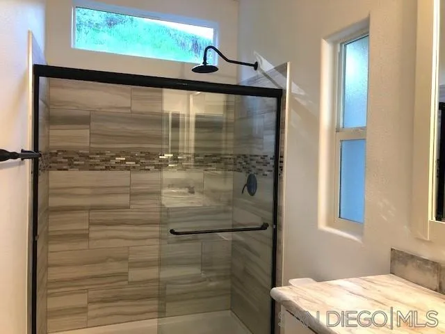 1315 Pepper Drive, Unit 18 El Cajon, CA 92021 - Photo 7 of 10 a bathroom with a glass shower door