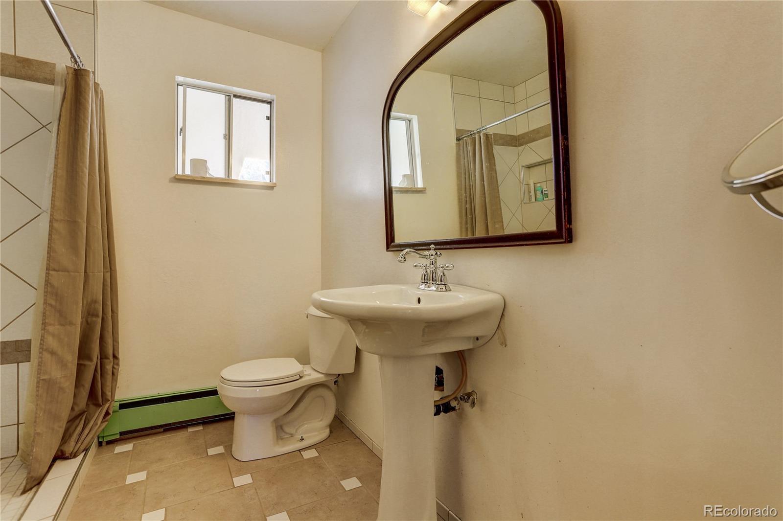 191 Anderson Road Bailey, CO 80421 - Photo 23 of 38 a bathroom with a sink toilet and mirror