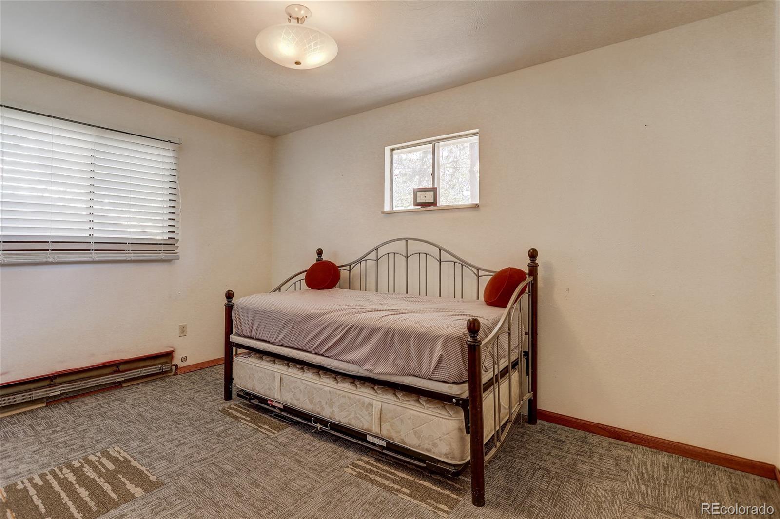 191 Anderson Road Bailey, CO 80421 - Photo 25 of 38 a spacious bedroom with a bed and a window