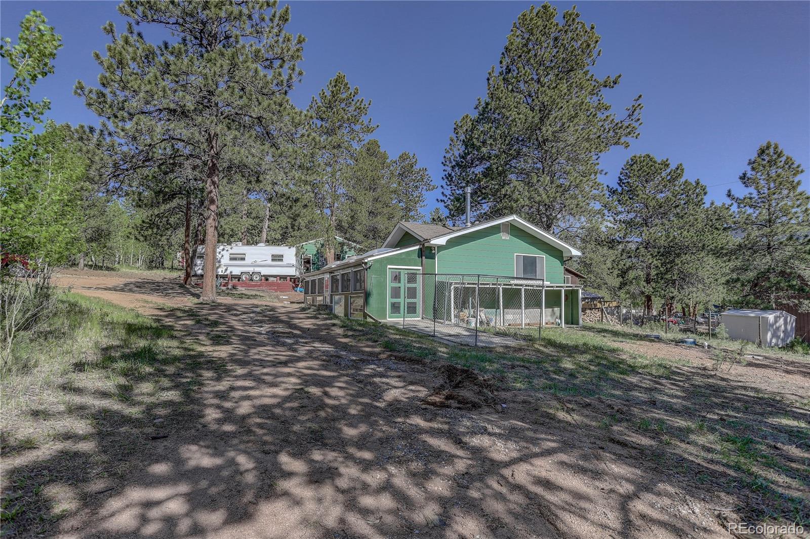 191 Anderson Road Bailey, CO 80421 - Photo 34 of 38 a dirt road with trees in the background