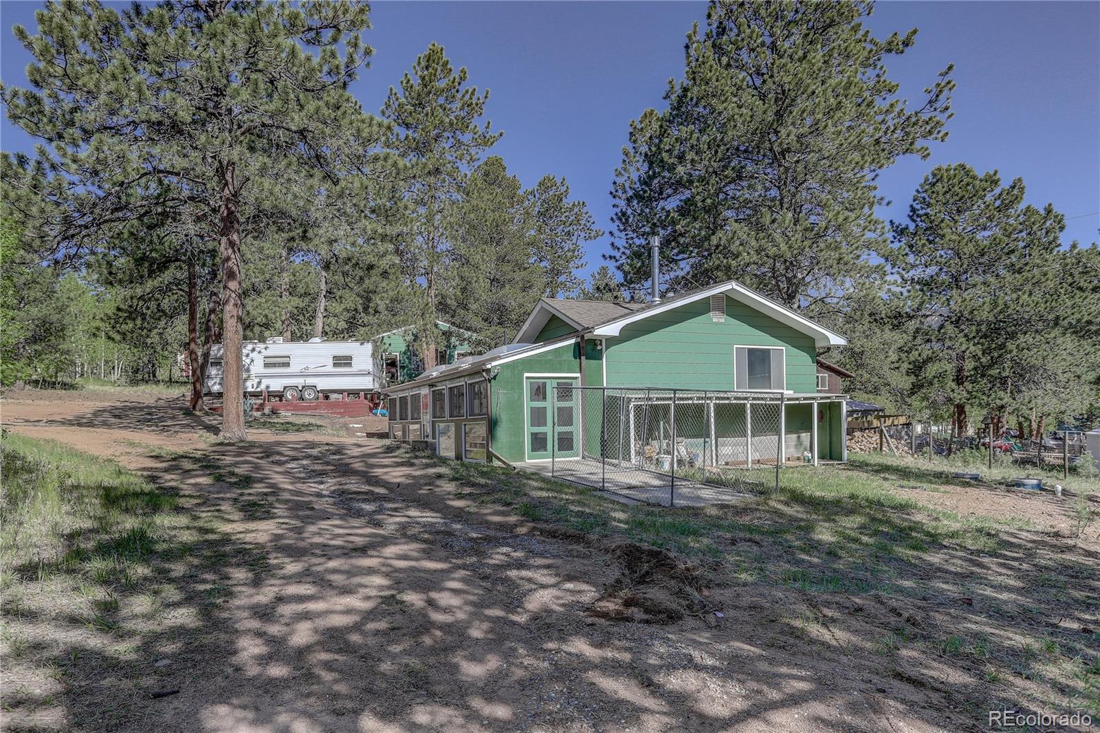 191 Anderson Road Bailey, CO 80421 - Photo 4 of 38 a front view of a house with a yard