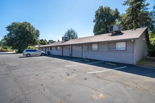 a view of a parking space in front of a building